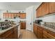 Kitchen with wood cabinets, granite countertops, and a large island at 9236 Arbor Glen St, Las Vegas, NV 89123