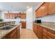 Functional kitchen with granite counters, wooden cabinets, and stainless steel sink at 9236 Arbor Glen St, Las Vegas, NV 89123