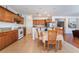 Bright kitchen with wood cabinets, granite counters, tile floors and cozy dining area at 9236 Arbor Glen St, Las Vegas, NV 89123