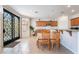 Eat-in kitchen featuring a breakfast bar, tile flooring, and wooden cabinetry at 9236 Arbor Glen St, Las Vegas, NV 89123