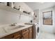 Functional laundry room with front loading washer, wooden cabinets, and tile flooring at 9236 Arbor Glen St, Las Vegas, NV 89123