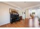 Open-concept living room featuring wood floors, piano and stairs to second floor at 9236 Arbor Glen St, Las Vegas, NV 89123