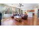 Cozy Living Room featuring wood floors, a leather sectional sofa, and bright windows at 9236 Arbor Glen St, Las Vegas, NV 89123