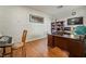 Bright office featuring wood floors, large desk, shelves, and a keyboard at 9236 Arbor Glen St, Las Vegas, NV 89123