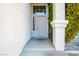 Beige front door entryway with sidelights and landscaping at 10332 Splendor Ridge Ave, Las Vegas, NV 89135