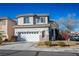 Two-story house with attached garage and landscaped front yard at 10332 Splendor Ridge Ave, Las Vegas, NV 89135