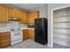 Kitchen with wood cabinets, black appliances and pantry at 10332 Splendor Ridge Ave, Las Vegas, NV 89135