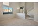 Living room with high ceilings, staircase, and large window at 10332 Splendor Ridge Ave, Las Vegas, NV 89135