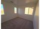 Bright bedroom with neutral carpeting and large windows at 11998 Camden Brook St, Las Vegas, NV 89183