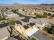 Aerial view of house with solar panels and backyard in a residential area at 165 Arrow Point Ln, Henderson, NV 89011