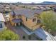 Two-story house with solar panels, driveway, and desert landscape at 165 Arrow Point Ln, Henderson, NV 89011