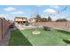 Backyard with artificial turf, seating area, and a tree at 165 Arrow Point Ln, Henderson, NV 89011