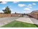 Landscaped backyard with a paved patio, artificial turf, and a sand area at 165 Arrow Point Ln, Henderson, NV 89011