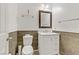 Clean bathroom with white vanity, wood-look accents, and toilet at 165 Arrow Point Ln, Henderson, NV 89011