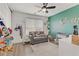 Bedroom with green accent wall, crib, and comfy couch at 165 Arrow Point Ln, Henderson, NV 89011