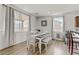 Bright dining room with white table, bench seating, and hardwood floors at 165 Arrow Point Ln, Henderson, NV 89011