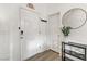 Bright entryway with white door, wood-look floors, and a small table at 165 Arrow Point Ln, Henderson, NV 89011