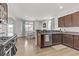 Open concept kitchen with island, stainless steel appliances, and hardwood floors at 165 Arrow Point Ln, Henderson, NV 89011