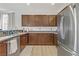 Spacious kitchen with stainless steel appliances and dark wood cabinets at 165 Arrow Point Ln, Henderson, NV 89011