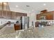 Modern kitchen with granite countertops and dark brown cabinets at 165 Arrow Point Ln, Henderson, NV 89011