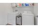 Convenient laundry room with washer, dryer, and shelving at 165 Arrow Point Ln, Henderson, NV 89011