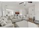 Open concept living room with sectional sofa and view of kitchen at 165 Arrow Point Ln, Henderson, NV 89011