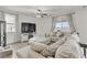 Living area with sectional sofa, ottoman, and large TV at 165 Arrow Point Ln, Henderson, NV 89011