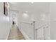 Upstairs hallway with white railings, wood flooring, and accent wall at 165 Arrow Point Ln, Henderson, NV 89011