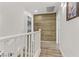 Upstairs hallway with white railings and wood-look flooring and a feature wall at 165 Arrow Point Ln, Henderson, NV 89011