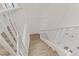 Upstairs hallway with white railings and wood-look flooring at 165 Arrow Point Ln, Henderson, NV 89011