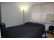 Cozy bedroom with a dark gray comforter and floor lamp at 1764 Sunflower Ct, Henderson, NV 89074