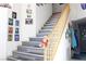 Wooden staircase with gray laminate flooring and framed Gathering photos at 1764 Sunflower Ct, Henderson, NV 89074