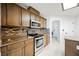 Kitchen with wood cabinets, granite counters, and stainless steel appliances at 1960 S Vineyard Dr, Pahrump, NV 89048