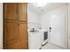 Laundry room with washer, dryer, and wood cabinets at 1960 S Vineyard Dr, Pahrump, NV 89048