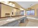 Elegant bathroom with double sinks, large mirror, and a soaking tub at 1968 Revere Ct, Henderson, NV 89014