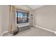 Bright bedroom with large window, grey bench, and ample floor space at 1968 Revere Ct, Henderson, NV 89014