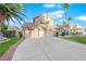 Two-story house with a three-car garage and manicured lawn at 1968 Revere Ct, Henderson, NV 89014