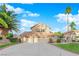 Two-story house with three-car garage, landscaped yard, and palm trees at 1968 Revere Ct, Henderson, NV 89014