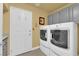 Bright laundry room with washer, dryer, and storage at 1968 Revere Ct, Henderson, NV 89014