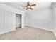 Bright bedroom with ceiling fan, carpet, and mirrored closet doors at 2000 Goldhill Ave, Las Vegas, NV 89106