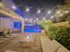 Relaxing backyard with pool, fire pit, and string lights at 201 White Mule Ave, Las Vegas, NV 89148