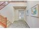 Bright entryway with tiled floors and a staircase with wooden railings at 201 White Mule Ave, Las Vegas, NV 89148