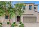 Two-story house with stone accents, a three-car garage, and a landscaped front yard at 201 White Mule Ave, Las Vegas, NV 89148