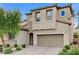 Two-story house with stone accents, a three-car garage, and a landscaped front yard at 201 White Mule Ave, Las Vegas, NV 89148