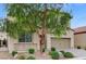 Two-story house with stone accents, a two-car garage, and a landscaped front yard at 201 White Mule Ave, Las Vegas, NV 89148