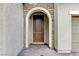 Elegant front door with stone archway and a brick pathway at 201 White Mule Ave, Las Vegas, NV 89148