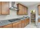 Kitchen with gas cooktop, wood cabinets, and walk-in pantry at 201 White Mule Ave, Las Vegas, NV 89148