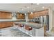 Kitchen with large island, stainless steel appliances, and wood cabinets at 201 White Mule Ave, Las Vegas, NV 89148