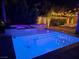 Night view of a luxurious pool and spa with integrated hot tub at 201 White Mule Ave, Las Vegas, NV 89148