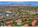 Aerial view of a community with pool, surrounded by residential buildings and shopping center, mountains in the background at 2200 S Fort Apache Rd # 1065, Las Vegas, NV 89117